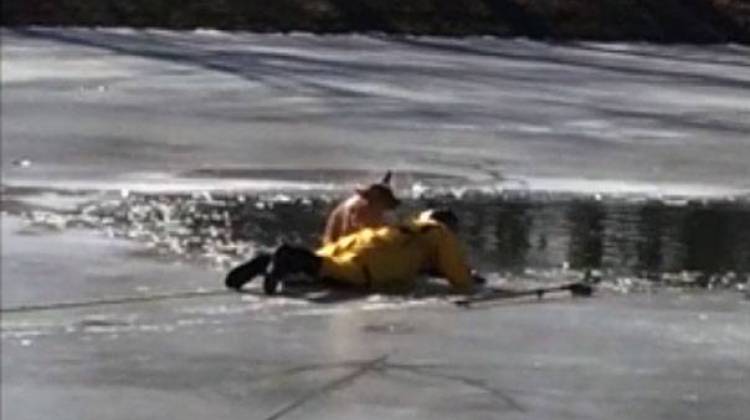 A Wayne Township firefighter rescues a dog from an icy pond. on Tuesday, Jan. 20. - Screen capture of YouTube video posted by Michael Pruitt.