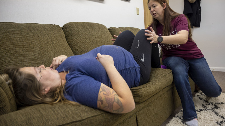 Bethany Gates, a certified professional midwife, examines her client Mandy King, who is due to give birth in less than two weeks. King has three children and this birth will be her first home birth. - (Natalie Krebs/Side Effects Public Media)