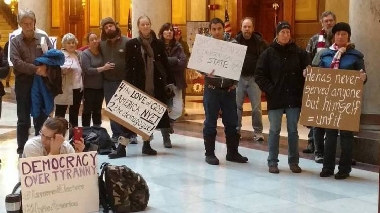 About 50 people protested outside the House chambers before the vote and in the Statehouse rotunda after. - Becca Costello