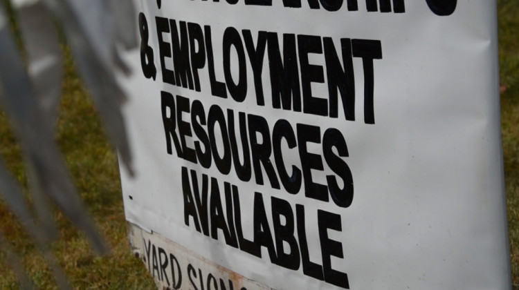 A sign outside Nu Corinthian Baptist Church in Indianapolis advertises employment resources at a weekly food handout during the pandemic.  - Justin Hicks / IPB News