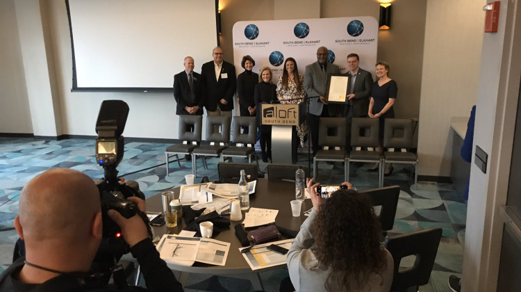 Local and state leaders in workforce and education pose with a "21st Century Talent Region" proclamation issued by Gov. Eric Holcomb.  - (Justin Hicks/IPB News)