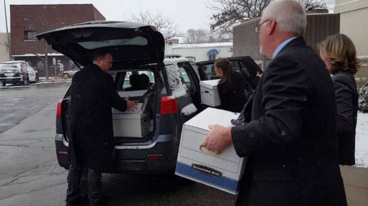 FBI agents load boxes taken from the office of the Muncie Building Commissioner's office. - Tony Sandleben
