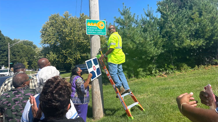 Neighborhood leaders put up the "Flanner House Homes Historic District" Sign. The stars on the sign honor U.S. veterans and access to housing in the neighborhood.  - Sydney Dauphinais
