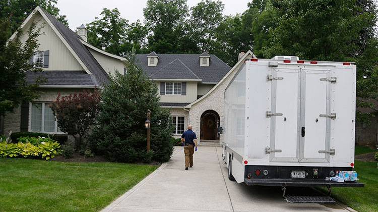 Federal authorities walk into the home of Subway restaurant spokesman Jared Fogle in Zionsville. -  AP Photo/Michael Conroy