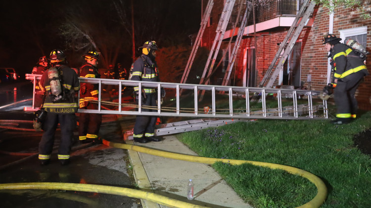 Firefighters used ground ladders to rescue at least 30 people from the building. - Courtesy of the Indianapolis Fire Department