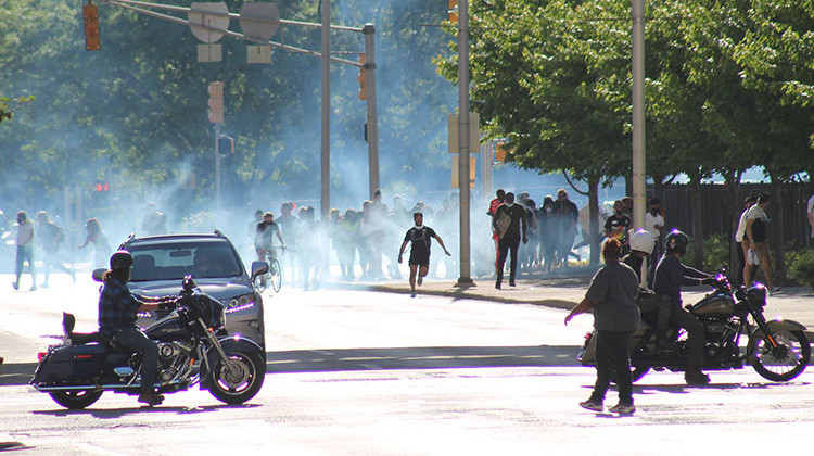 Demonstrators flee tear gas at the corner of New York Street and Capitol Ave.nue on Sunday, May 31. - Lauren Chapman/IPB News
