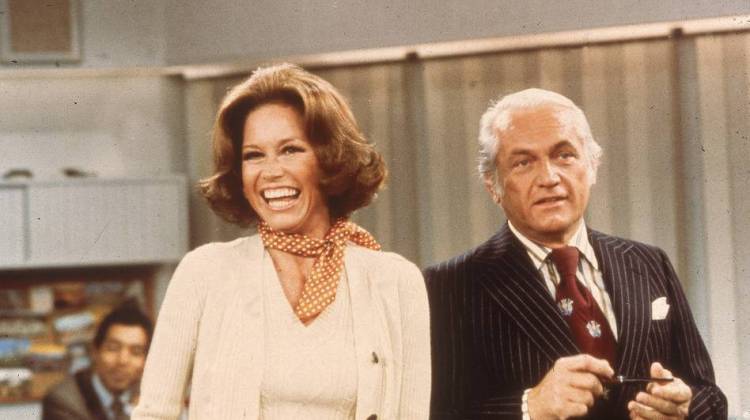 Actors Mary Tyler Moore and Ted Knight laugh in a still from The Mary Tyler Moore Show in 1976. - 20th Century Fox Television/Fotos International/Getty Images