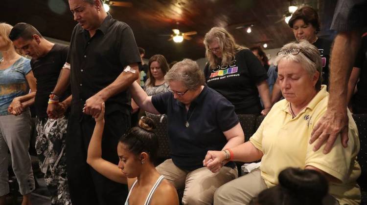 On the afternoon after a deadly attack on a nightclub in Orlando, Fla., a man who says he was wounded in the violence was among those attending a memorial service at the Joy MCC Church. Police say a lone gunman killed 49 people in the attack.