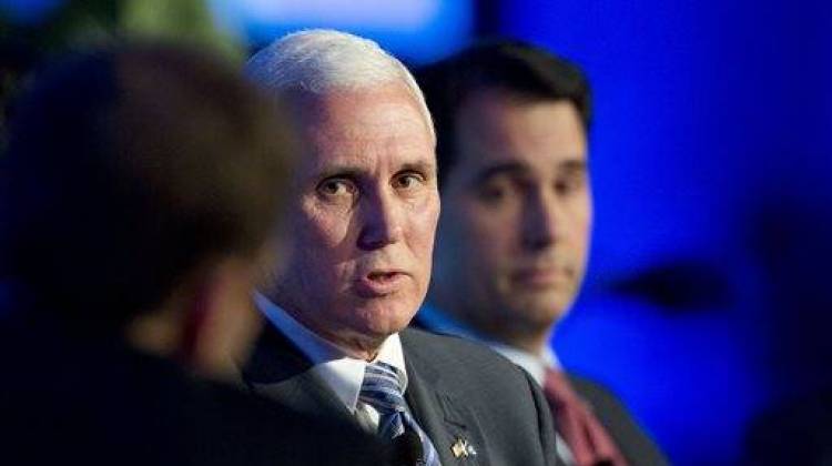 Indiana Gov. Mike Pence, left, talks about recent Republican party gains and the road ahead for their party during a press conference at the Republican governors' conference in Boca Raton, Fla., Wednesday, Nov. 19, 2014. - The Associated Press