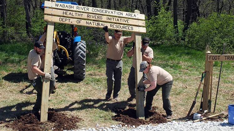 Indiana Division of Fish and Wildlife staff work to install a sign at the Wabash River Conservation Area. - Healthy Rivers INitiative via Facebook
