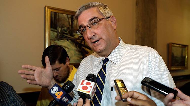 Indiana Lt. Gov. Eric Holcomb responds to questions after carrying paperwork into the Indiana Secretary of State's office in Indianapolis. Friday, July 15, 2016, to remove his name from the ballot for re-election.  - AP Photo/Darron Cummings