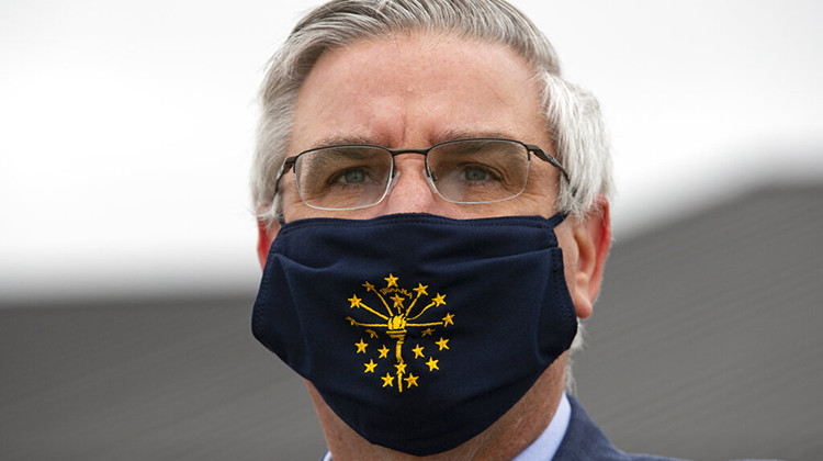 FILE - In this Thursday, April 30, 2020 file photo, Gov. Eric Holcomb wears a mask in Kokomo. - AP Photo/Michael Conroy, File