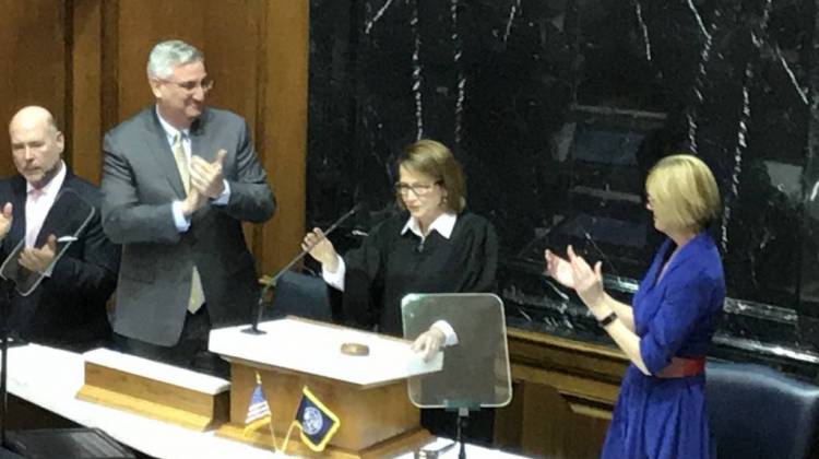 Gov. Eric Holcomb (left) and Lt. Gov. Suzanne Crouch (right) applaud Chief Justice Loretta Rush as she completes her State of the Judiciary address. - Brandon Smith/IPB News