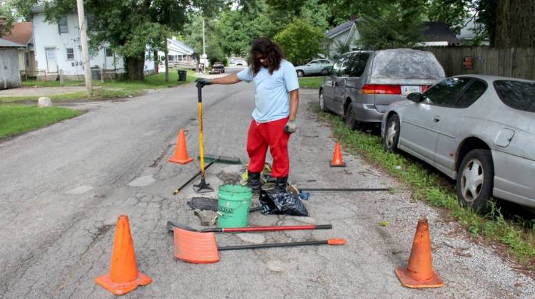 Michael Warren has spent about $400 out-of-pocket this summer to fill potholes in his Indianapolis neighborhood.  - Annie Ropeik/IPB News