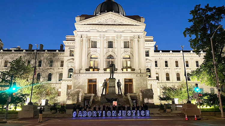 Abortion rights supporters gathered outside the Statehouse in a silent protest on the eve of Indiana’s near-total abortion ban becoming law, Wednesday, Sept. 14, 2022. - Emilie Syberg/WFYI