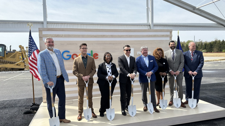 Indiana Gov. Eric Holcomb (left), Fort Wayne Mayor Sharon Tucker (third from left), and Sen. Todd Young (middle) join Google executives and others at the groundbreaking for the $2 billion data center project in southeast Fort Wayne. - Brittany Smith / WBOI News