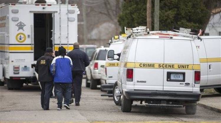 Indianapolis Metropolitan Police Department personnel investigate a scene involving four homicide victims at a house on North Harding Street, Tuesday, March 24, 2015, in Indianapolis. - The Associated Press
