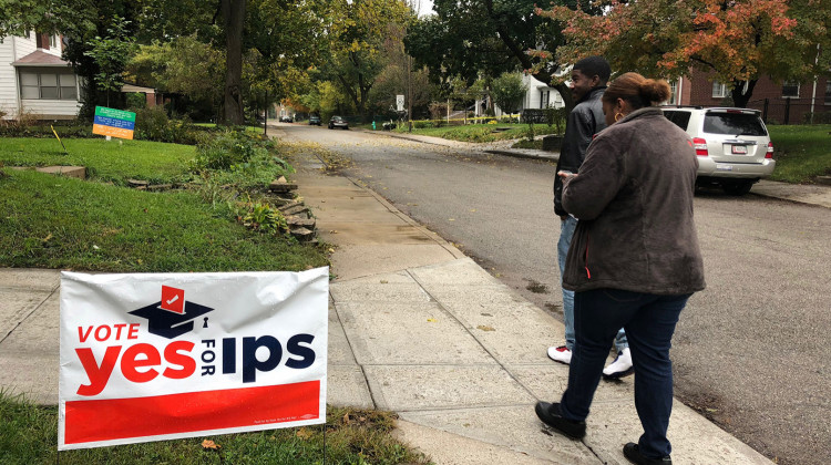 Joel Williams and Charisse McGill from Stand for Children canvass the neighborhood north of 38th street near Deleware street. They're working to convince voters to pass the IPS referenda on the general ballot. - Carter Barrett/WFYI