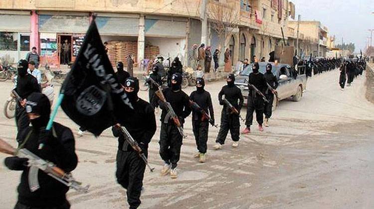 This undated file image posted on a militant website Jan. 14, 2014 shows Islamic State militants marching through Raqqa, Syria. - AP Photo/Militant Website, File