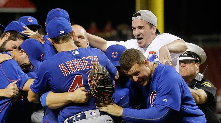 Dylan Cressy, top right, ran onto the field to celebrate with Chicago Cubs starting pitcher Jake Arrieta (49) and his teammates after Arrieta threw a no-hitter against the Cincinnati Reds, Thursday, April 21, 2016. - AP Photo/John Minchillo