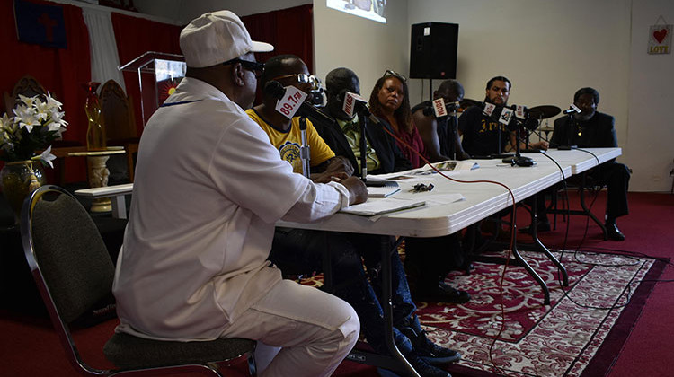 Family members of Eric Logan, city council members, and others sit on a panel at a radio station to discuss the investigation of Logan's death.  - Justin Hicks/IPB News