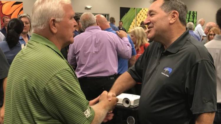 U.S. Sen. Joe Donnelly (D-Indiana), center, speaks with a constituent at the Indiana State Fair. - Brandon Smith/IPB