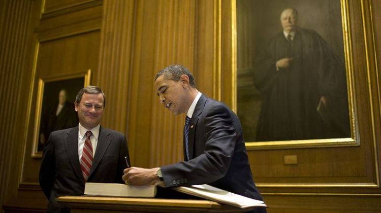 Chief Justice John Roberts looks on as Present-Elect Barack Obama signs the guest book at the U.S. Supreme Court in 2009. - Pete Souza/Obama Transition Team/CC-BY-3.0