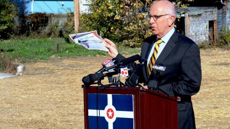 Marion County Prosecutor Terry Curry holds a political mailer at a press conference. - Ryan Delaney/WFYI