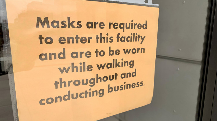 Signs posted at entrances to the Statehouse tell visitors they must wear masks inside.  - Brandon Smith/IPB News