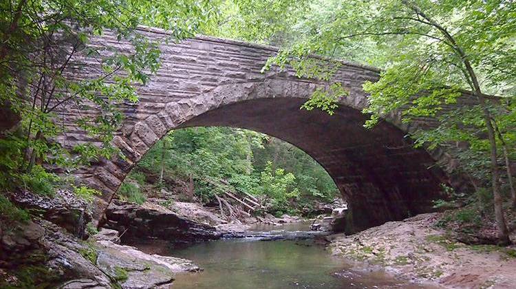 A bridge over McCormick's Creek in McCormick's Creek State Park, which was established in 1916.   - McGhiever, CC-BY-SA-3.0