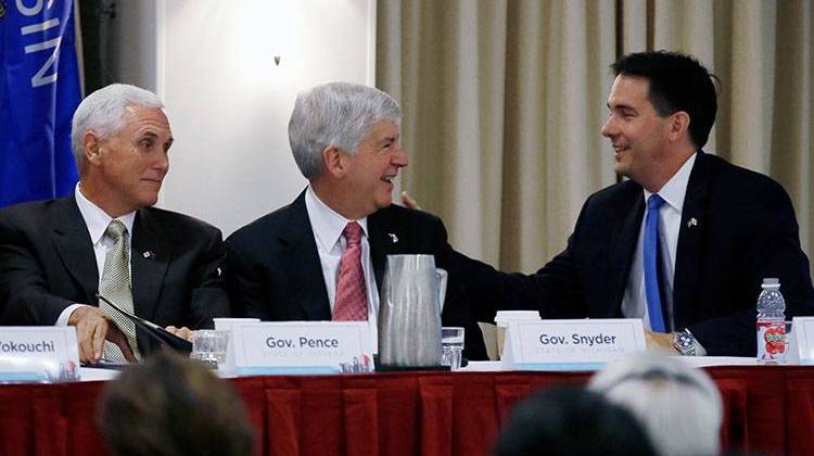 Wisconsin Gov. Scott Walker, right, talks with Indiana Gov. Mike Pence, left, and Michigan Gov. Rick Snyder, center, during the annual meeting of the Midwest U.S-Japan Association, Monday, Sept. 8, 2014, in Des Moines, Iowa.  - AP Photo/Charlie Neibergall