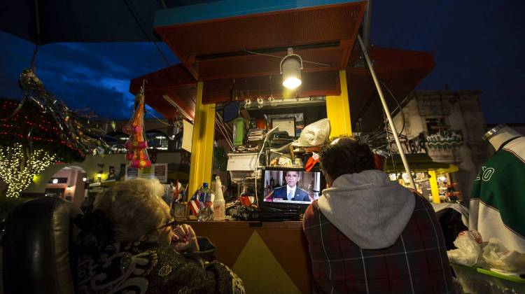 In California, Plaza Mexico's vendors Maria Sanchez, 72, and son Luis Garcia watching President Obama's speech on his executive action on immigration, Thursday Nov. 20, 2014. - The Associated Press