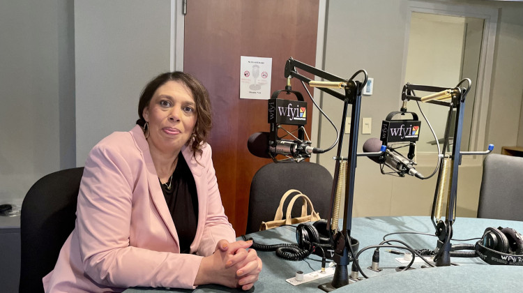 PACE Executive Director Rhiannon Edwards, pictured here in the WFYI studio, visited the station to discuss the program's new location. - Darian Benson / WFYI News