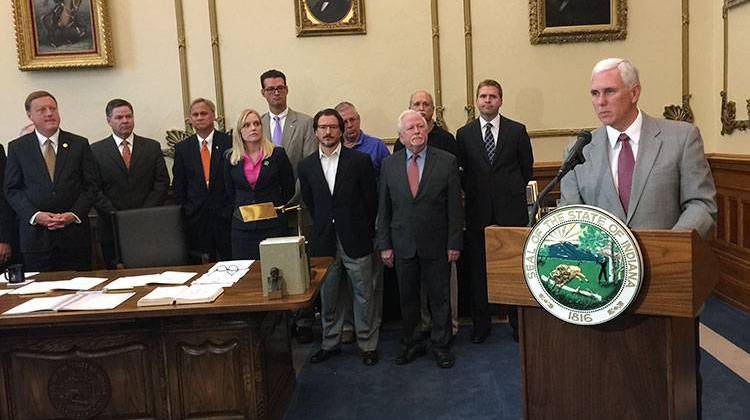 Governor Mike Pence ceremonially signed two bills into law Wednesday that will expand broadband Internet access across the state. - Payne Horning