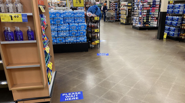 Stickers on the floor of a Kroger in Bloomington, Indiana, show how far apart customers should stand in checkout lines. - Lauren Bavis/Side Effects Public Media