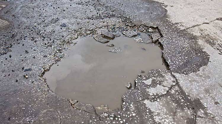 Public Works Director Dan Parker says a lot of the cityâ€™s pavement issues are caused by a lack of drainage. - File photo