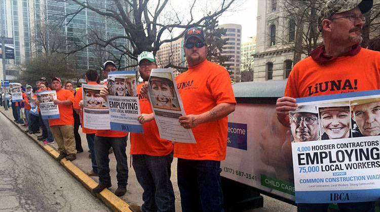 Union workers gathered outside the Statehouse Monday morning ahead of a rally against repeal of the common construction wage. - StatehouseFile.com