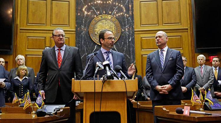 Scott McCorkle, center, CEO Salesforce.com, joins Indiana Senate President Pro Tem David Long, left, (R-Fort Wayne) and House Speaker Brian C. Bosma (R-Indianapolis) as they announce changes to RFRA. - AP Photo/Michael Conroy