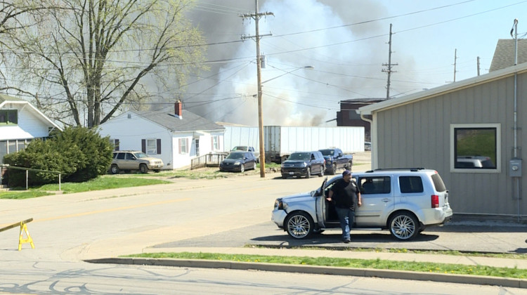 Grey and white smoke billows out of the two warehouses that caught fire. Firefighters have contained the fire, but it was still burning as of Wednesday afternoon. - Rebecca Thiele/IPB News