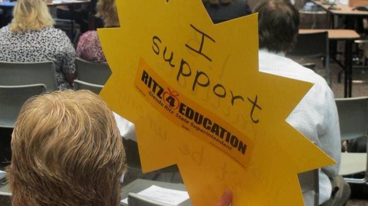A crowd member shows her support for State Superintendent Glenda Ritz during July's State Board of Education meeting. - Rachel Morello/StateImpact Indiana