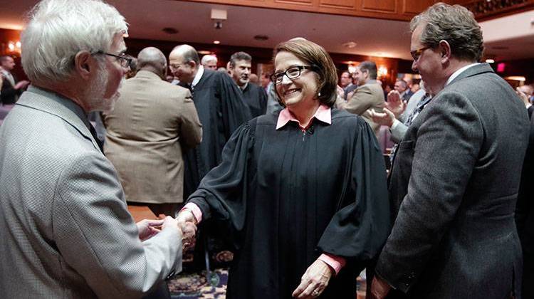 Indiana Chief Justice Loretta Rush is greeted by Sen. Tim Lanane, D-Anderson, as she walks to the podium to deliver her first state of the judiciary speech to a joint session at the Statehouse Wednesday. -  AP Photo/Darron Cummings