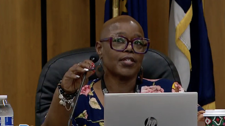 IPS Board Vice President Angelia Moore shows a photo depicting violent incidents within the school district during Thursday's meeting  - (Photo taken from YouTube)