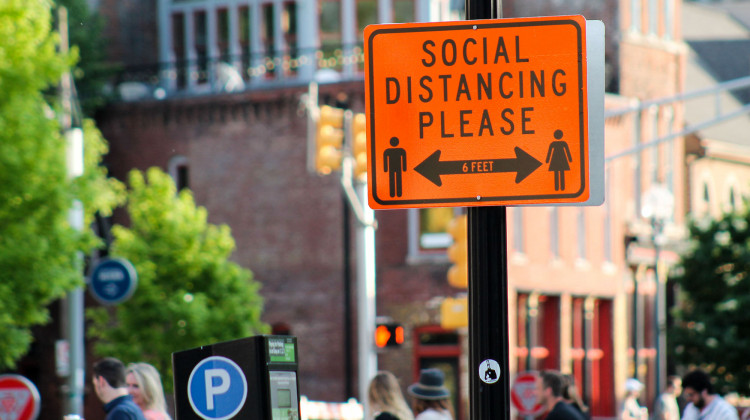 Downtown Indianapolis blocked parts of Mass Ave. to allow outdoor seating. The city also installed signs, reminding people to social distance while visiting businesses and restaurants. - Lauren Chapman/IPB News