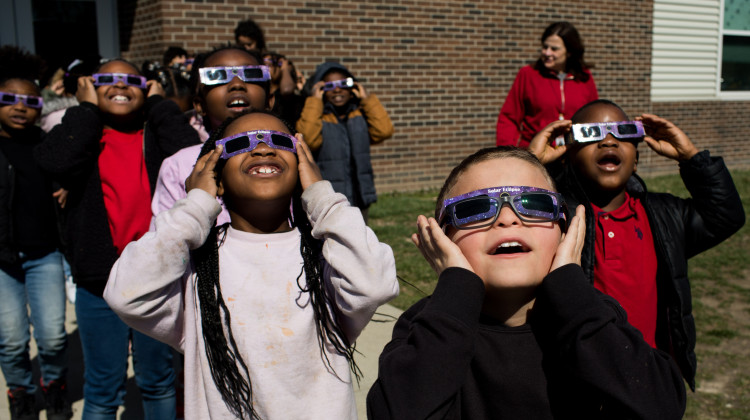Second graders practice using solar eclipse glasses outside Winchester Village Elementary School in Indianapolis. - Kaiti Sullivan / NPR