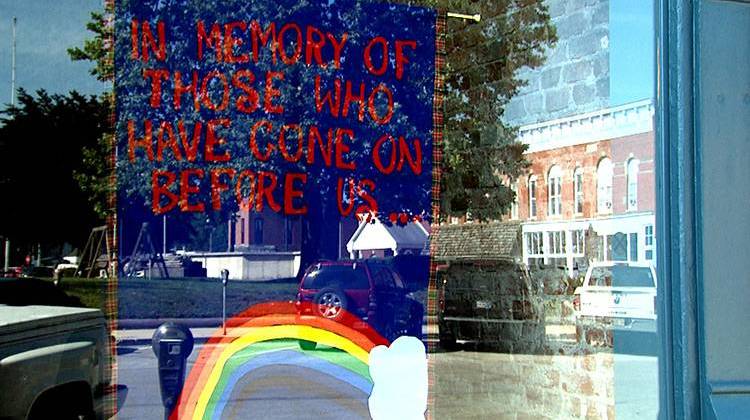 A makeshift memorial to victims of the Orlando attack hangs in the window of Spencer Pride in downtown Spencer, Indiana. - Barbara Brosher