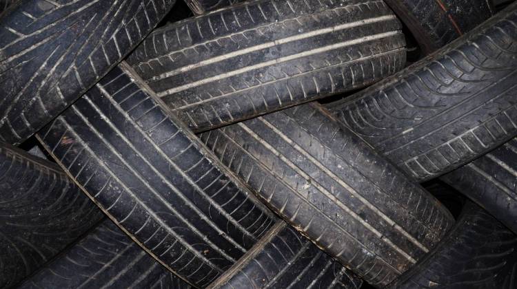 Unused tires, when left outside, can collect water and become an ideal place for mosquitoes to lay eggs. - stock photo