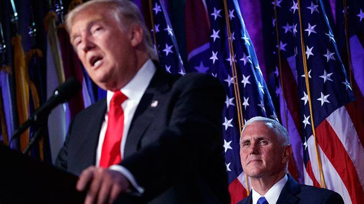 Vice president-elect Mike Pence, right, watches as President-elect Donald Trump speaks during an election night rally, Wednesday, Nov. 9, 2016, in New York. - AP Photo/ Evan Vucci