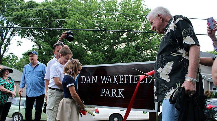Author and Indianapolis native Dan Wakefield cuts the ribbon on the new sign at the park now named for him. - Drew Daudelin