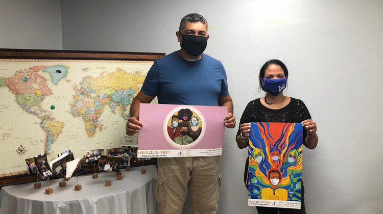 Two Natural Helper Specialists, Francisco Ruiz and Virna Diaz, collecting Mask Up posters to distribute to immigrant owned businesses for COVID-19 prevention. - Courtesy Immigrant Welcome Center