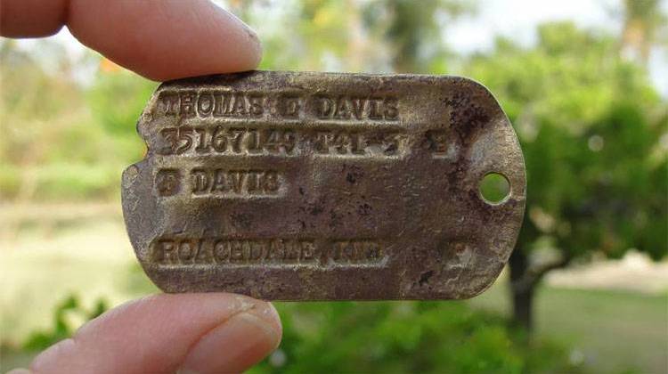 This Feb. 13 photo provided by Genevieve Cabrera shows World War II Pfc. Thomas E. Davis' Army dog tag that was found in a farm field on Saipan in early 2014. - Genevieve Cabrera via AP